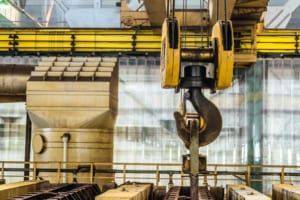 Steel hook of overhead crane over industrial equipment